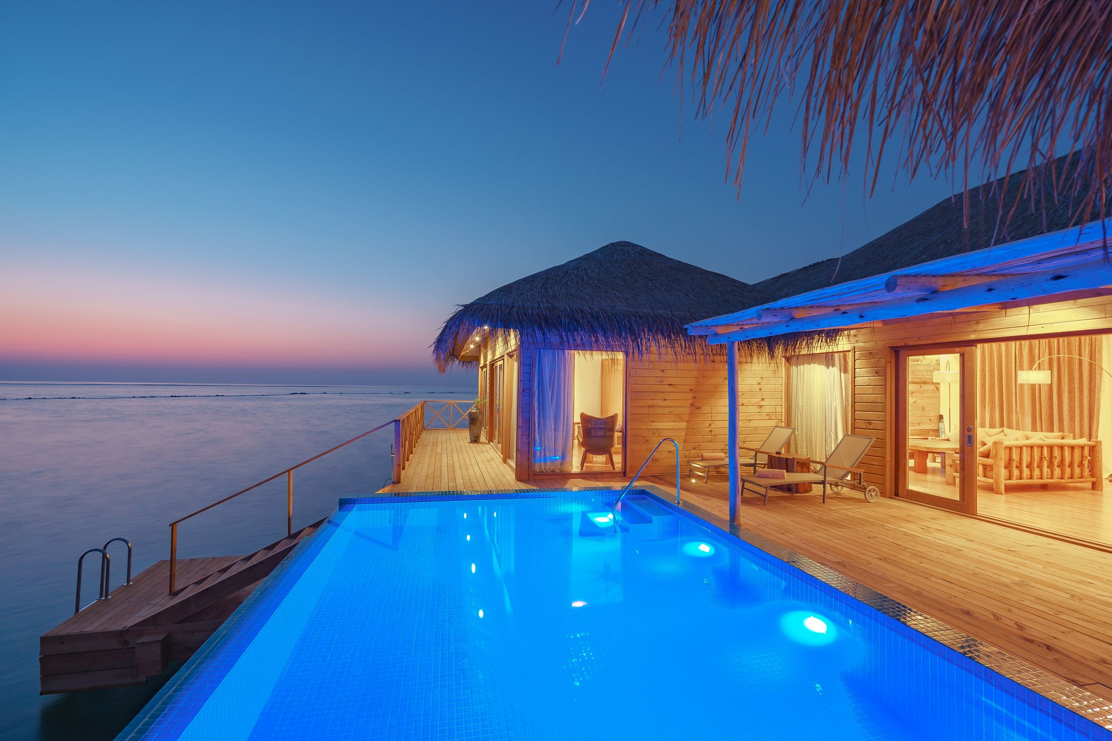 A private pool lit blue at night