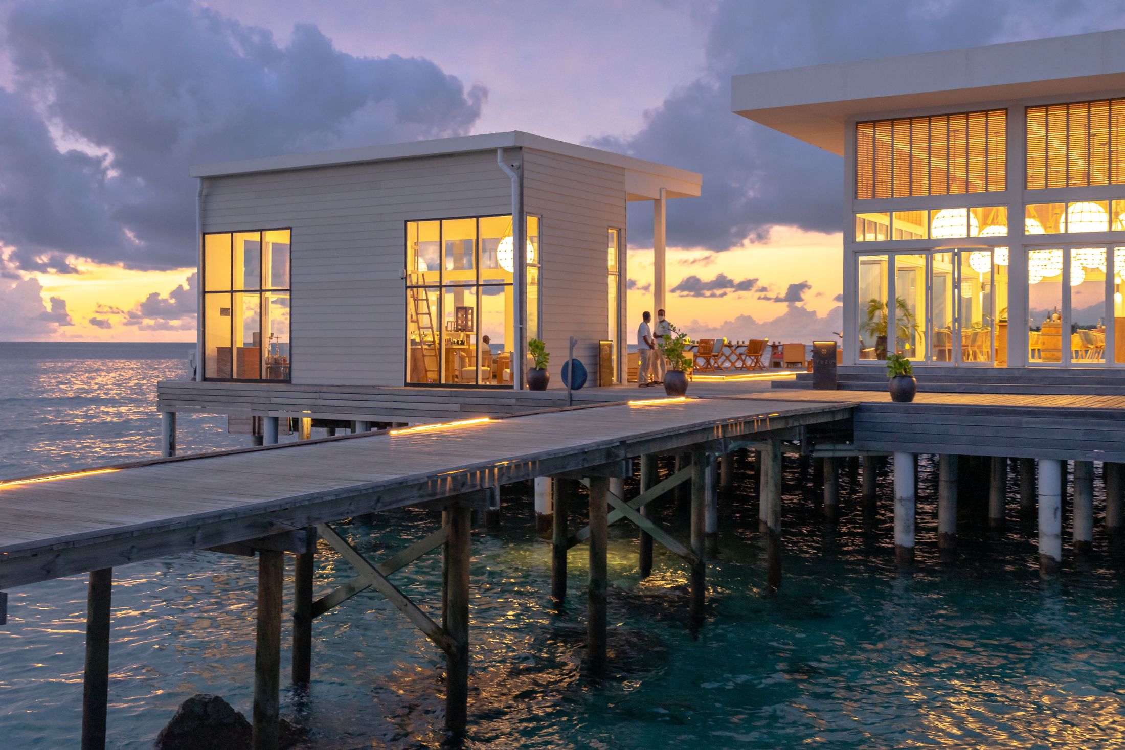 The overwater restaurant lit up at dusk