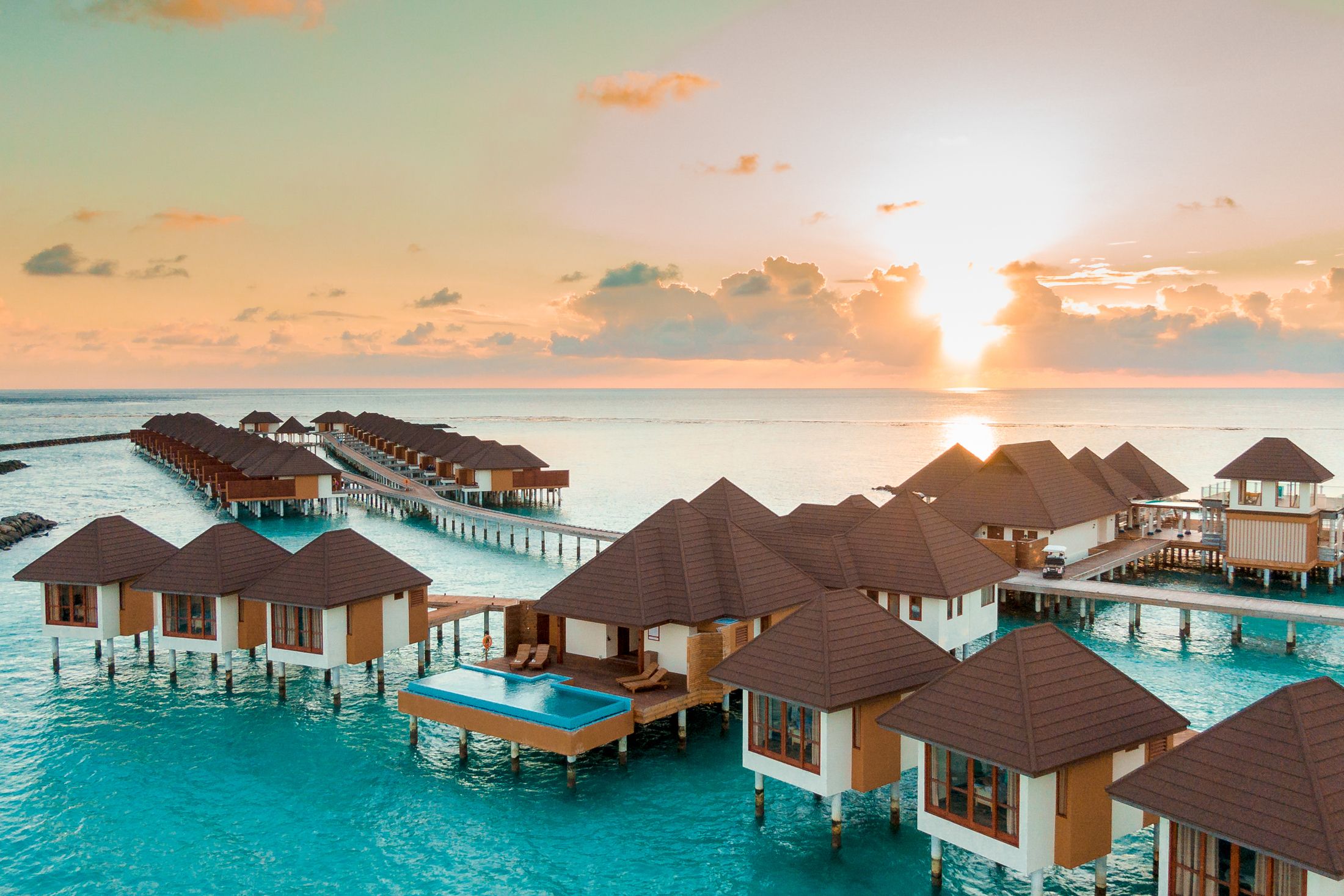 Overwater villas facing the setting sun
